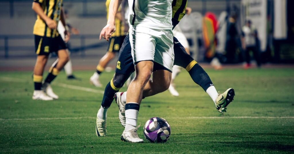 Close-up of soccer players in action during a match at an outdoor stadium.